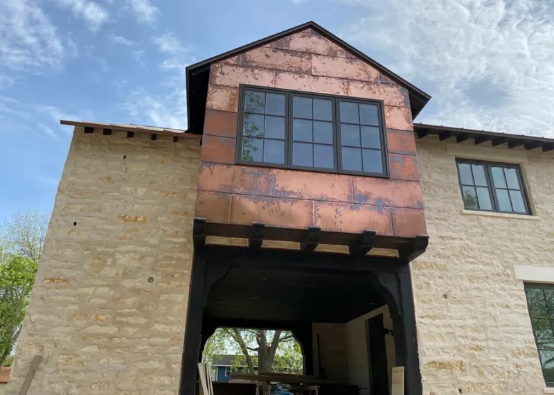 Copper metal panel facade on a stone building for Metal Roof Coating in Benton